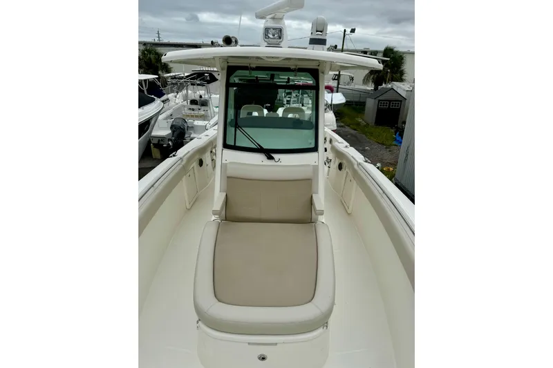 Overtime Yacht Photos Pics 2018 Boston Whaler 330 Outrage boat with cushioned seating and sleek design.