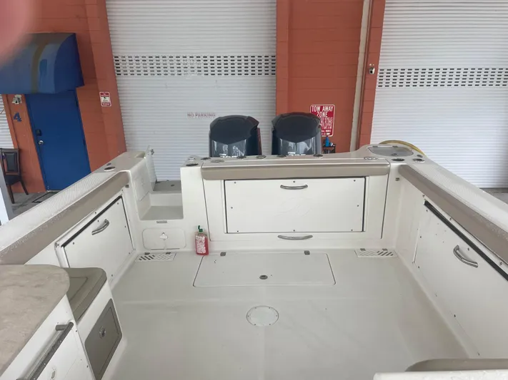  Yacht Photos Pics 2019 Sailfish 325 Dual Console boat interior with storage compartments and twin engines.