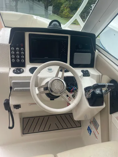  Yacht Photos Pics 2019 Sailfish 325 Dual Console boat cockpit with steering wheel and control panel.
