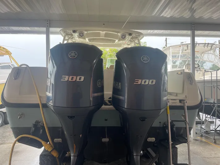  Yacht Photos Pics 2019 Sailfish 325 Dual Console with twin Yamaha 300 engines in a covered dock.
