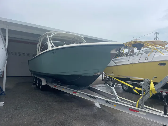  Yacht Photos Pics 2019 Sailfish 325 Dual Console boat on trailer in storage facility.
