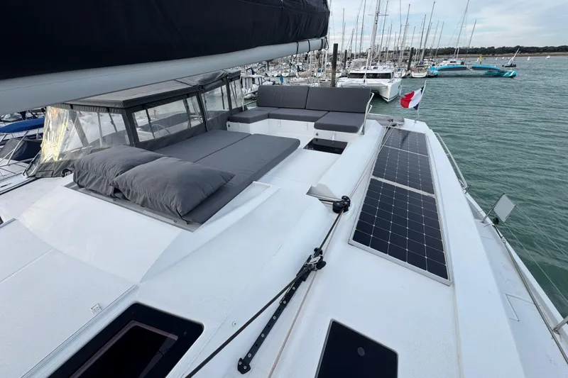 Lupa Di Mare Yacht Photos Pics 2021 Fountaine Pajot Saona 47 catamaran with solar panels and cushioned deck, docked in marina.