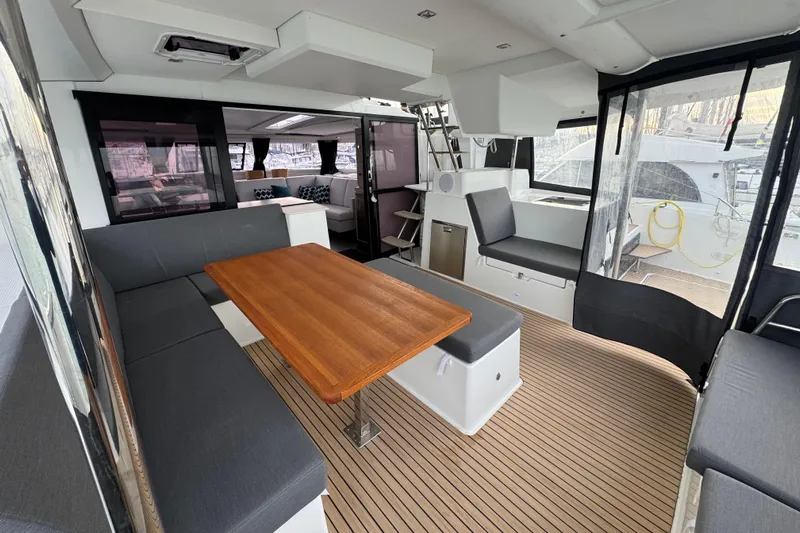 Lupa Di Mare Yacht Photos Pics Spacious interior of 2021 Fountaine Pajot Saona 47 catamaran with modern seating and wooden table.