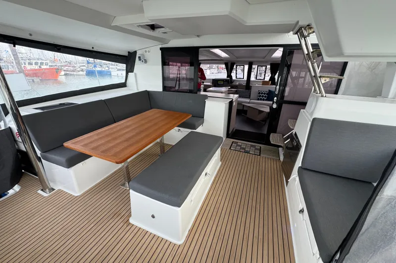 Lupa Di Mare Yacht Photos Pics Interior of 2021 Fountaine Pajot Saona 47 catamaran with modern seating and wooden table.