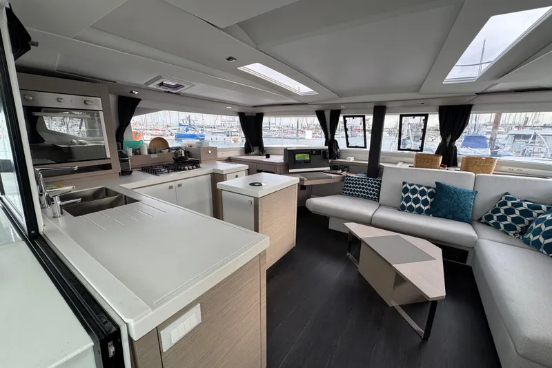 Lupa Di Mare Yacht Photos Pics Luxurious interior of 2021 Fountaine Pajot Saona 47 catamaran with modern kitchen and seating area.