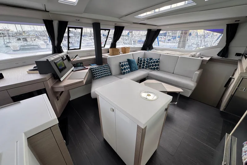Lupa Di Mare Yacht Photos Pics Luxurious interior of 2021 Fountaine Pajot Saona 47 catamaran with modern seating and navigation area.