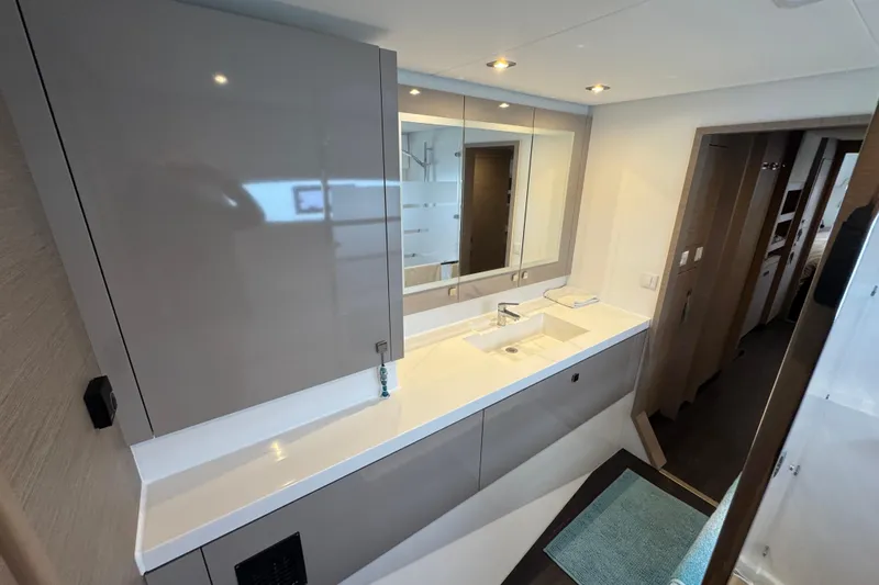 Lupa Di Mare Yacht Photos Pics Modern bathroom interior of 2021 Fountaine Pajot Saona 47 catamaran, featuring sleek design and ample storage.