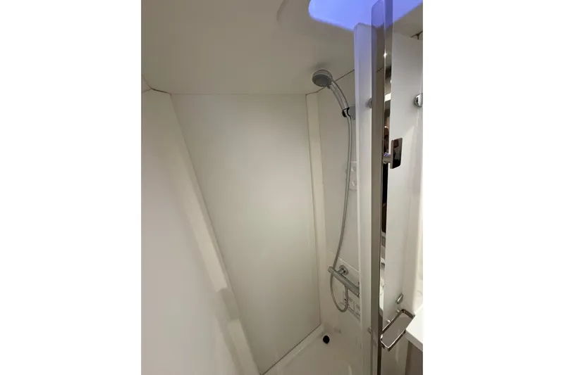 Lupa Di Mare Yacht Photos Pics Shower area in 2021 Fountaine Pajot Saona 47 catamaran, featuring modern fixtures.