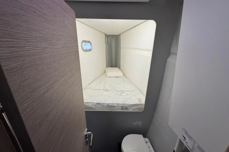 Lupa Di Mare Yacht Photos Pics Cabin interior of 2021 Fountaine Pajot Saona 47 catamaran with bed and porthole.