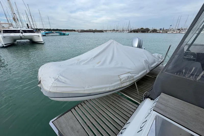 Lupa Di Mare Yacht Photos Pics Covered dinghy on Fountaine Pajot Saona 47 catamaran, docked in marina, 2021 model.