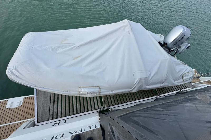 Lupa Di Mare Yacht Photos Pics Covered dinghy on 2021 Fountaine Pajot Saona 47 yacht with Honda outboard motor.