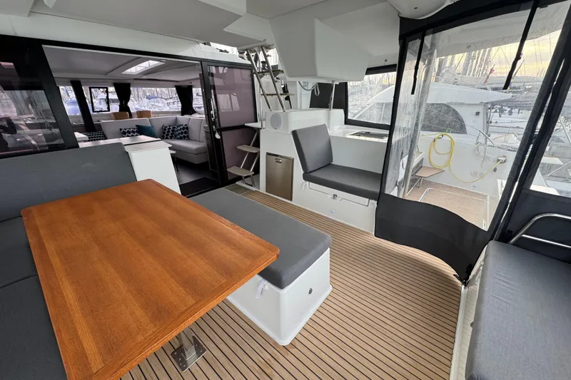 Lupa Di Mare Yacht Photos Pics Spacious interior of 2021 Fountaine Pajot Saona 47 catamaran with modern seating and wooden table.