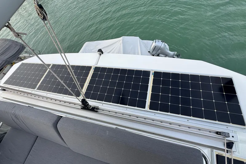 Lupa Di Mare Yacht Photos Pics Solar panels on a 2021 Fountaine Pajot Saona 47 catamaran, docked on calm water.