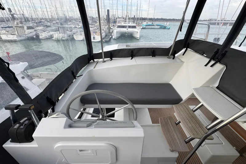 Lupa Di Mare Yacht Photos Pics Cockpit of 2021 Fountaine Pajot Saona 47 catamaran with steering wheel and seating area.