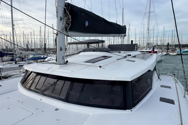 Lupa Di Mare Yacht Photos Pics 2021 Fountaine Pajot Saona 47 catamaran docked in a marina, showcasing sleek design.