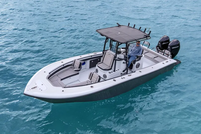  Yacht Photos Pics 2024 Yellowfin 26 Hybrid boat on clear blue water, featuring dual Mercury engines.