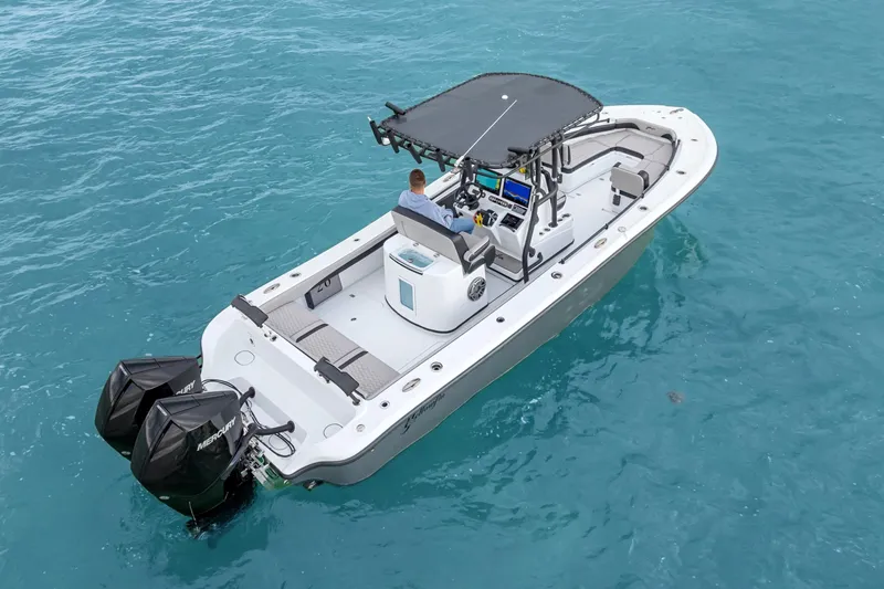  Yacht Photos Pics 2024 Yellowfin 26 Hybrid boat on clear blue water, featuring dual outboard engines.