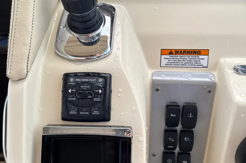  Yacht Photos Pics Control panel of 2016 Chris-Craft Launch 36 boat with warning label and buttons.