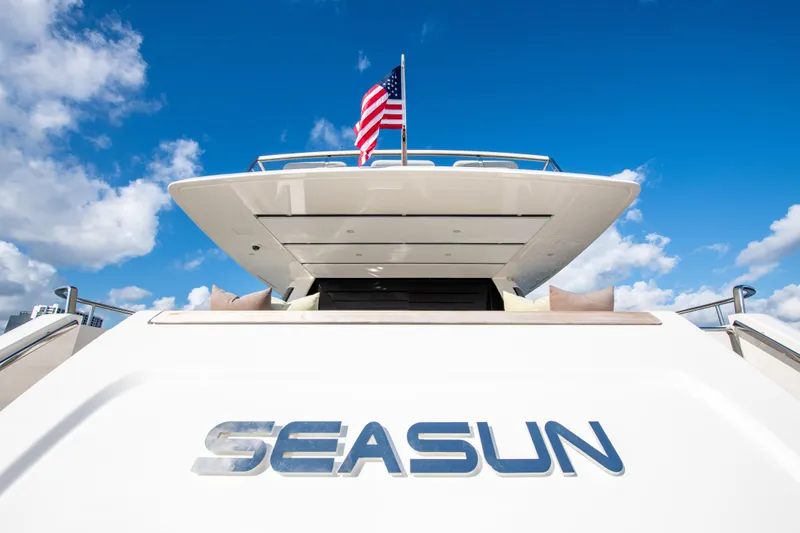 Seasun Yacht Photos Pics Sanlorenzo SL86 yacht "SEASUN" with American flag, 2016 model, under blue sky.