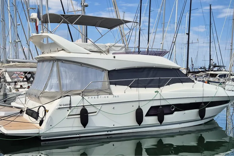 Ker Lann Yacht Photos Pics 2022 Prestige 460 yacht docked in marina, featuring sleek design and modern amenities.