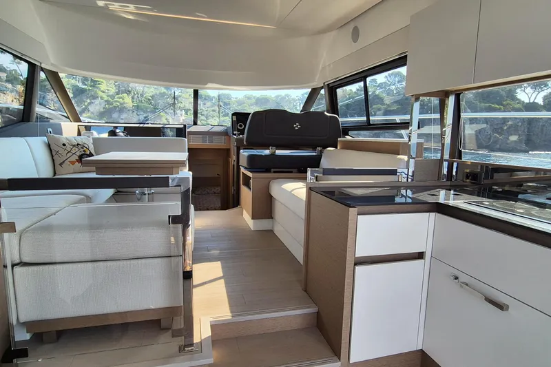 Ker Lann Yacht Photos Pics Luxurious interior of 2022 Prestige 460 yacht with modern furnishings and panoramic windows.