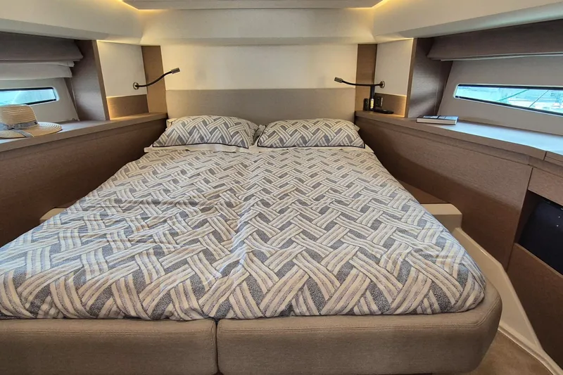 Ker Lann Yacht Photos Pics Luxurious bedroom interior of 2022 Prestige 460 yacht with modern bedding and ambient lighting.