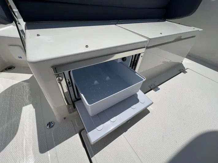 Chill Yacht Photos Pics Open storage compartment on a 2025 Nimbus T8 boat, featuring a sliding drawer.