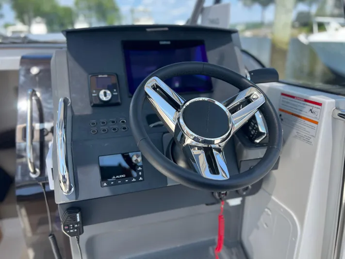 Chill Yacht Photos Pics Steering wheel and dashboard of 2025 Nimbus T8 boat, featuring modern controls and displays.