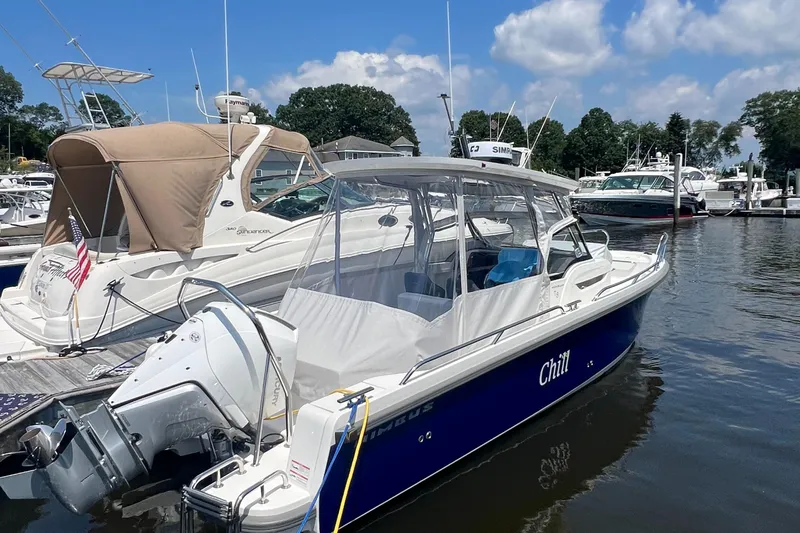 Chill Yacht Photos Pics 2025 Nimbus T8 boat named "Chill" docked at a marina under a blue sky.