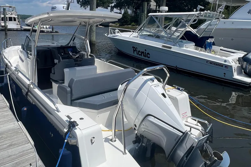 Chill Yacht Photos Pics 2025 Nimbus T8 boat docked, featuring sleek design and modern outboard motor.