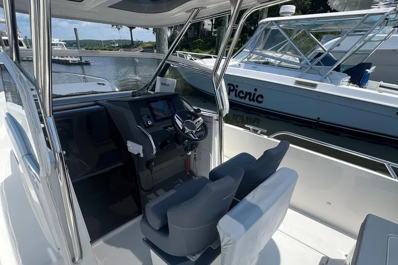 Chill Yacht Photos Pics Interior of a 2025 Nimbus T8 boat with modern steering and seating.