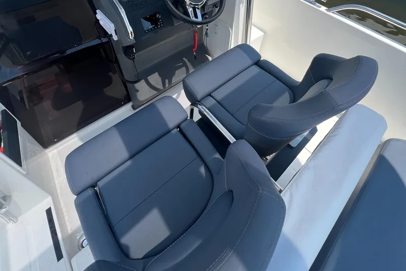 Chill Yacht Photos Pics Interior of 2025 Nimbus T8 boat with modern seating and steering wheel.