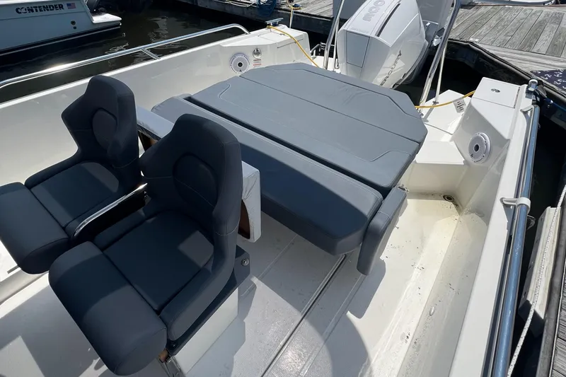 Chill Yacht Photos Pics 2025 Nimbus T8 boat interior with cushioned seating and modern design.