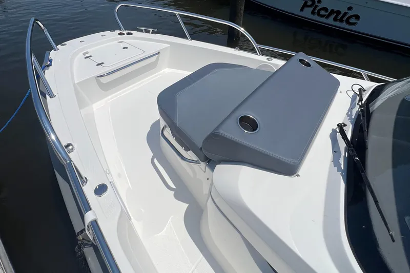 Chill Yacht Photos Pics Nimbus T8 2025 boat deck with seating and cup holders, docked near water.