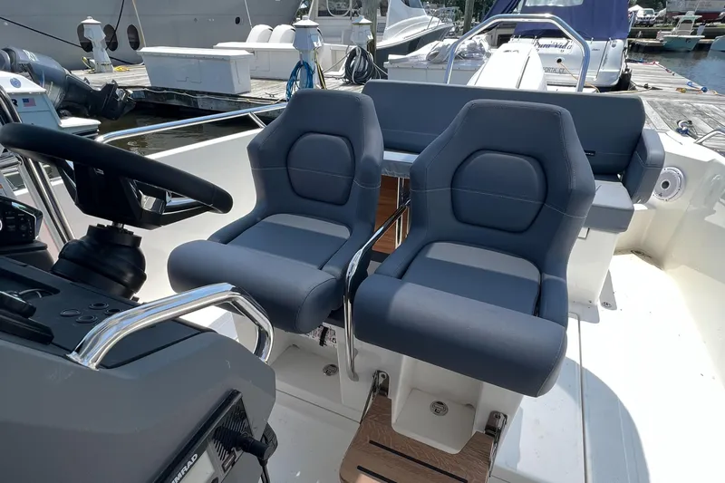 Chill Yacht Photos Pics Luxury seating on a 2025 Nimbus T8 boat, featuring modern design and comfort.