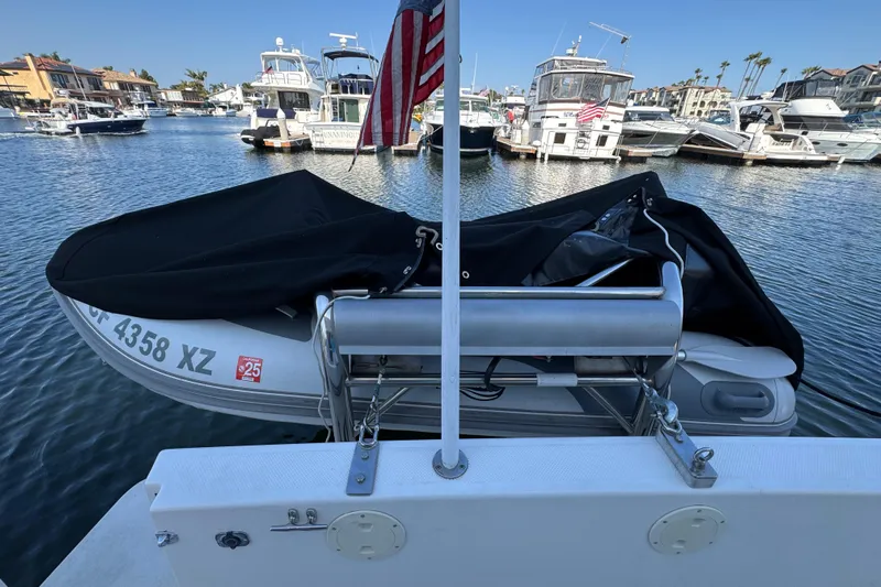 Interim Yacht Photos Pics 2001 Bayliner 4087 Aft Cabin Motoryacht with covered dinghy in marina setting.