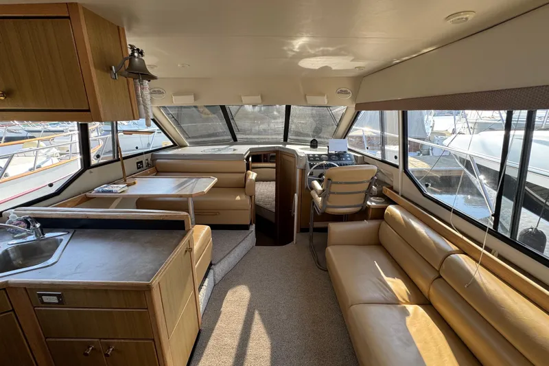 Interim Yacht Photos Pics Interior of 2001 Bayliner 4087 Aft Cabin Motoryacht with seating, helm, and kitchenette.