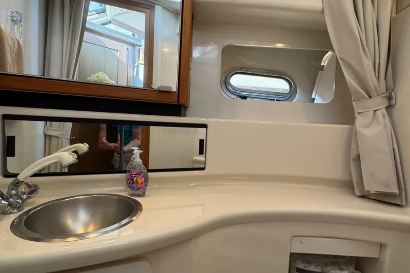 Interim Yacht Photos Pics Bathroom interior of 2001 Bayliner 4087 Aft Cabin Motoryacht with sink and mirror.
