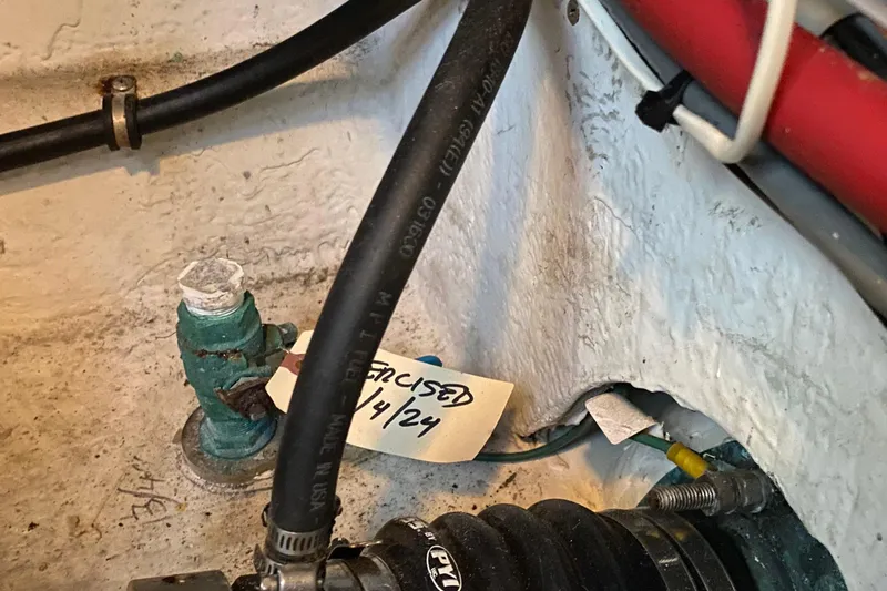 Interim Yacht Photos Pics Engine compartment of 2001 Bayliner 4087 Aft Cabin Motoryacht with hoses and maintenance tag.