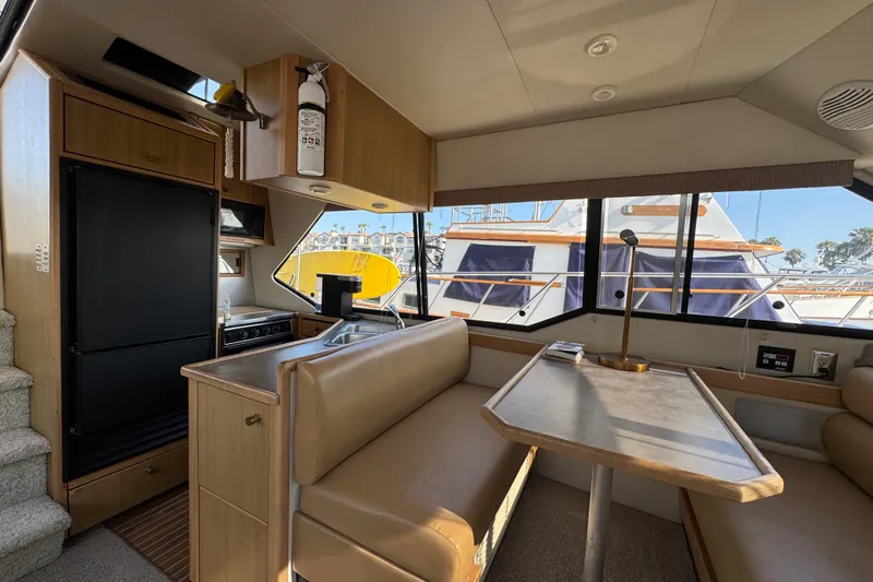 Interim Yacht Photos Pics Interior of 2001 Bayliner 4087 Aft Cabin Motoryacht with dining area and kitchenette.