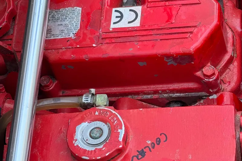 Interim Yacht Photos Pics Engine component of 2001 Bayliner 4087 Aft Cabin Motoryacht, featuring red casing and metal pipe.