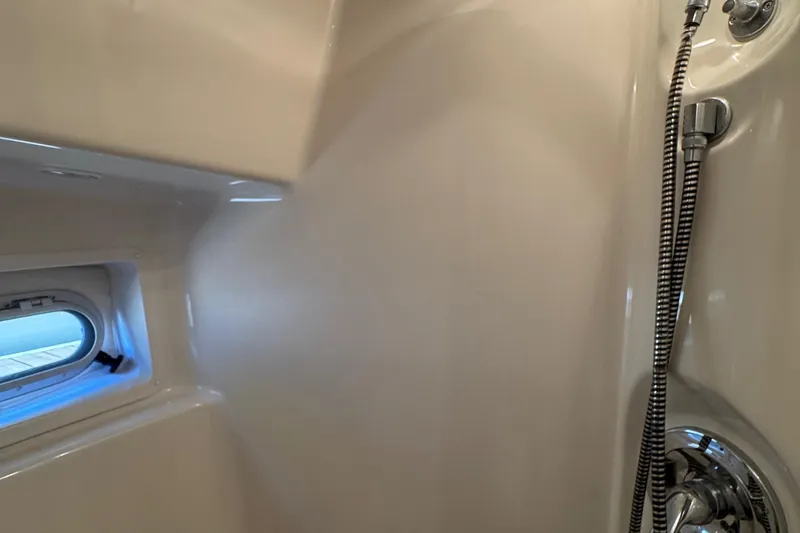 Interim Yacht Photos Pics Shower area in 2001 Bayliner 4087 Aft Cabin Motoryacht with window and chrome fixtures.