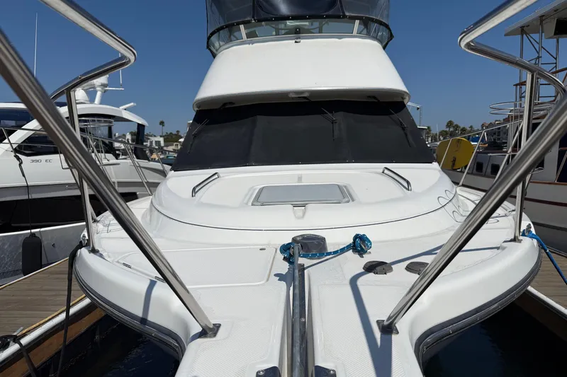 Interim Yacht Photos Pics 2001 Bayliner 4087 Aft Cabin Motoryacht docked, showcasing sleek design and spacious deck.