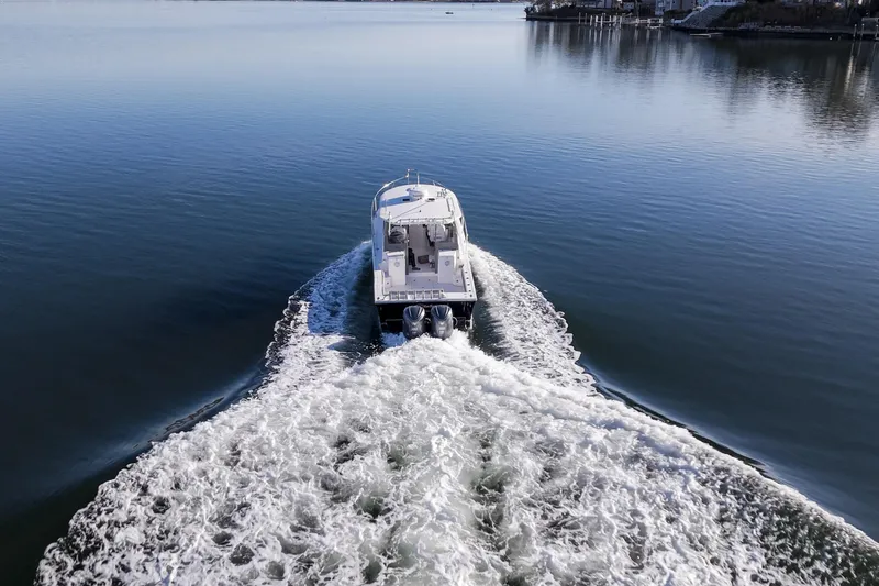 Challenger Yacht Photos Pics 2021 NorthCoast 315 HT boat cruising on calm water, leaving a wake.