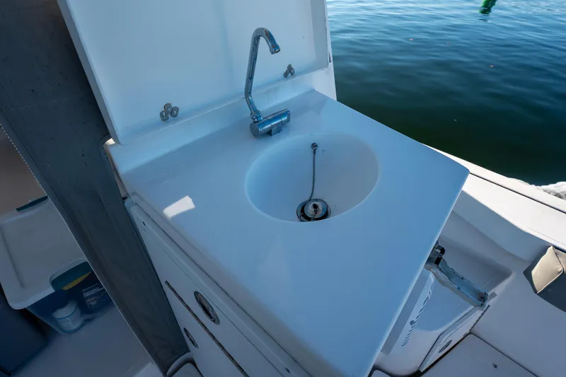 Challenger Yacht Photos Pics 2021 NorthCoast 315 HT boat sink with faucet, docked on calm water.