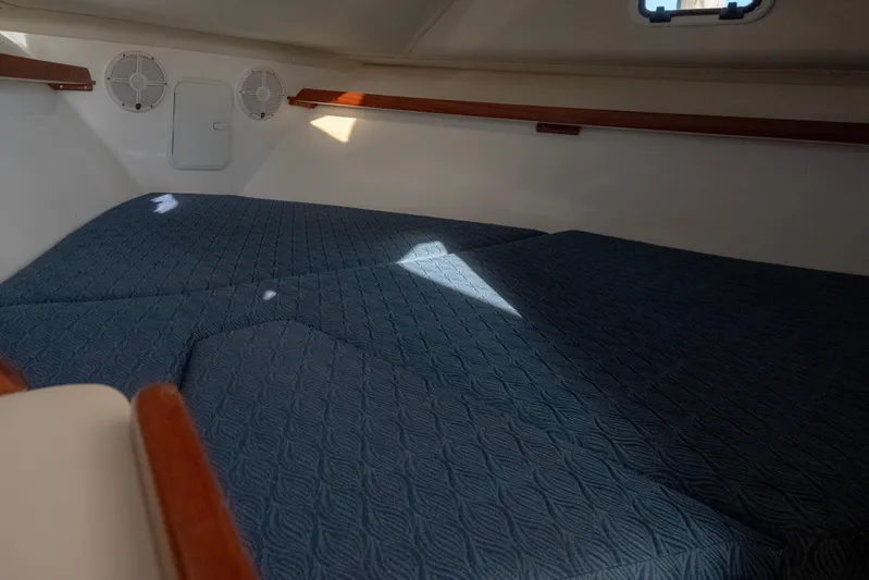 Challenger Yacht Photos Pics Interior cabin of 2021 NorthCoast 315 HT boat with blue quilted bedding.