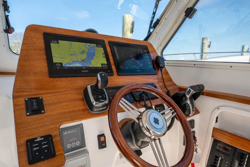 Challenger Yacht Photos Pics 2021 NorthCoast 315 HT helm with dual Garmin displays and wooden steering wheel.