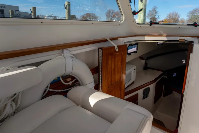 Challenger Yacht Photos Pics 2021 NorthCoast 315 HT boat interior with seating, life preserver, and cabin view.