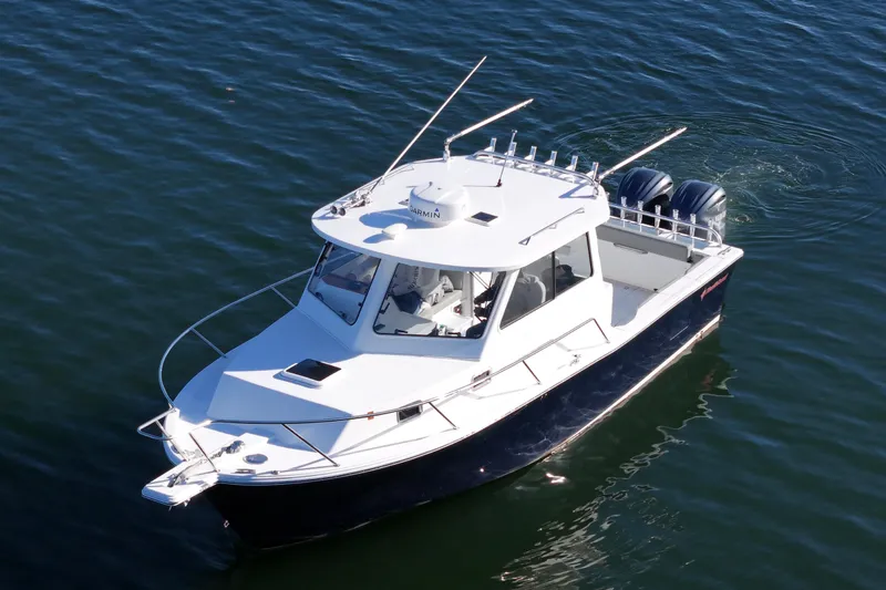 Challenger Yacht Photos Pics 2021 NorthCoast 315 HT boat cruising on calm water, aerial view.
