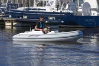 2023 AB Inflatables 350 XP boat on water near marina.